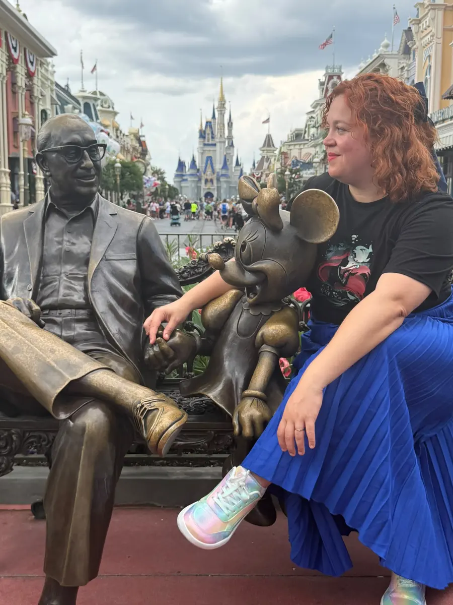 Lara junto a la estatua de Roy Disney y Minnie en Magic Kingdom